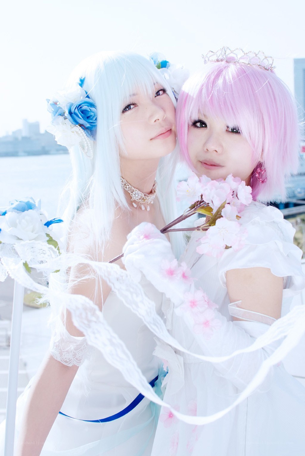Two cosplayers in white dresses