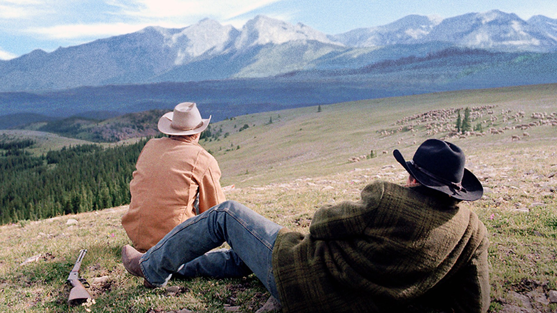 Two cowboys on a mountain overlook