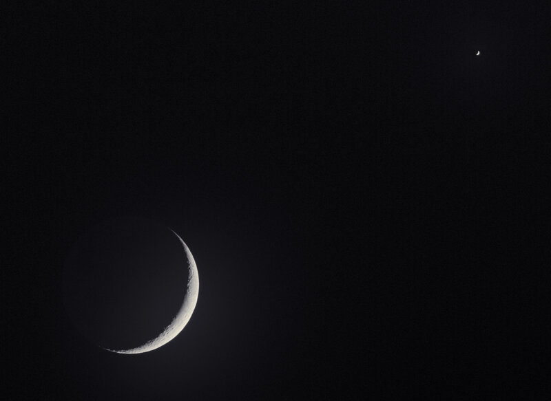 Two crescent moons in night sky