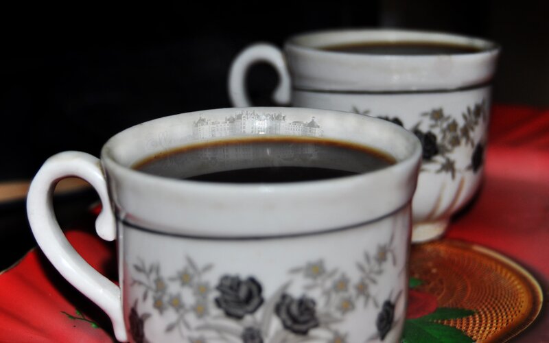 Two cups of coffee on red cloth