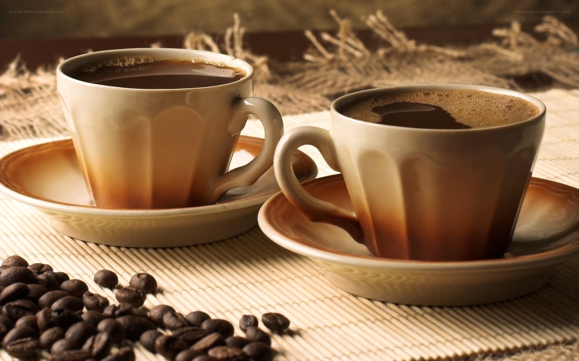 Two cups of coffee with beans