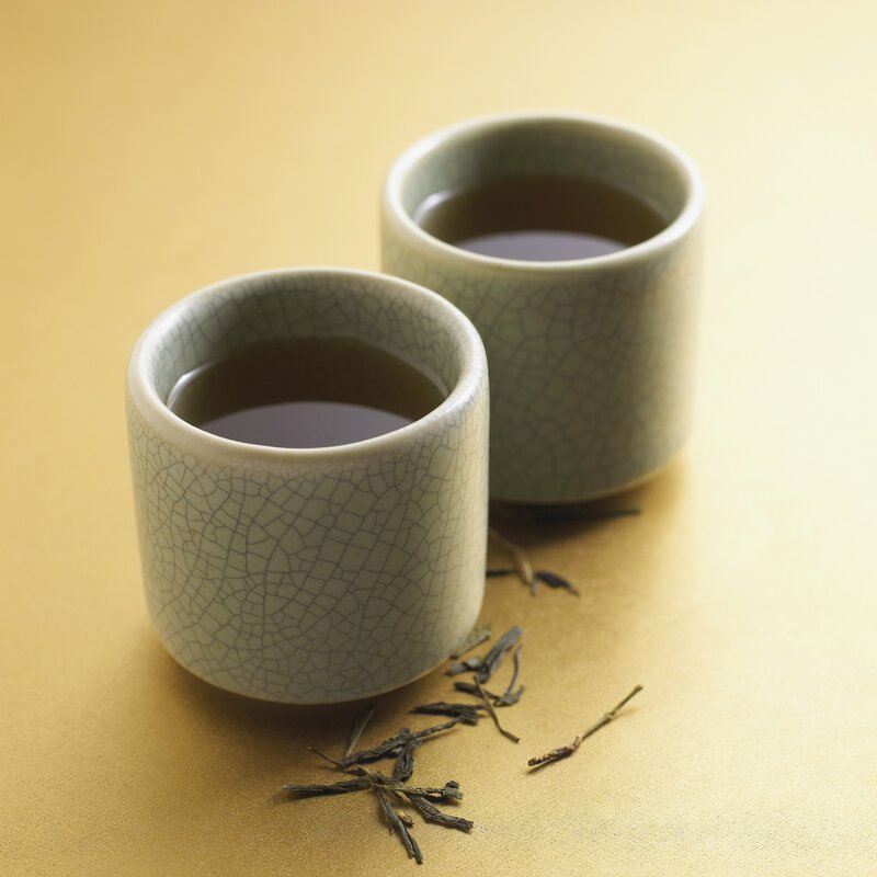 Two cups of tea with leaves