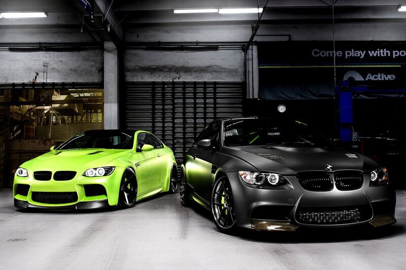 Two customized BMW cars in garage