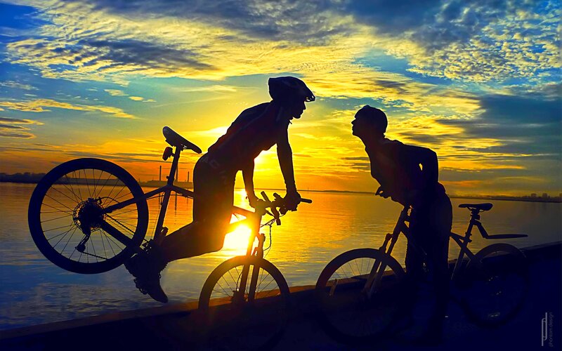 Two Cyclists at Sunset