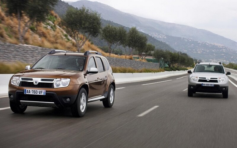 Two Dacia SUVs on a mountain road
