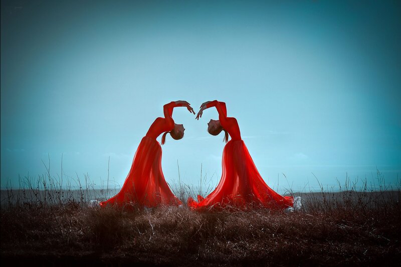 Two Dancers in Red Dresses