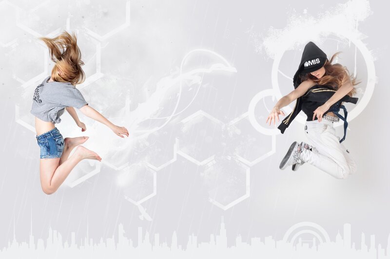 Two dancers jumping in mid-air