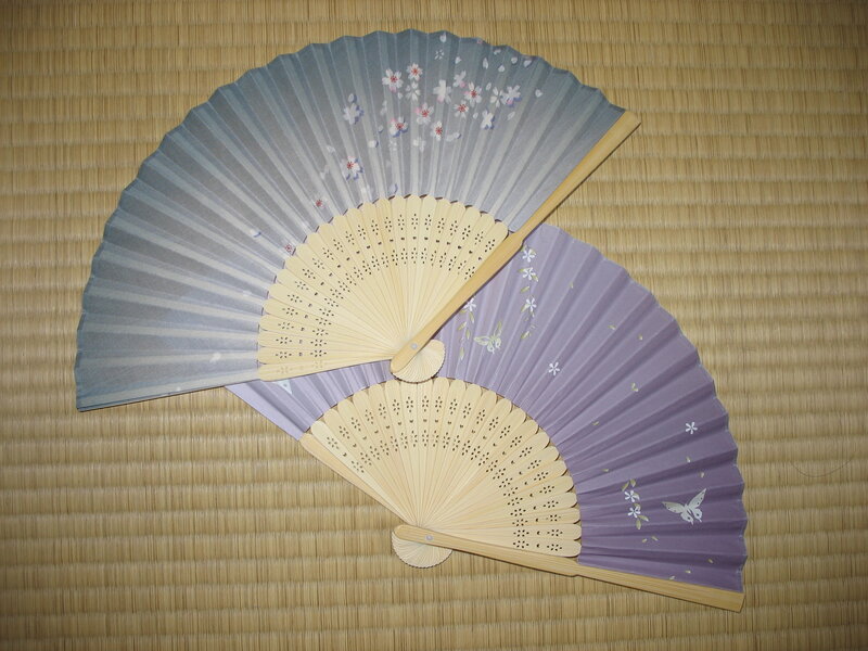Two decorative fans on mat