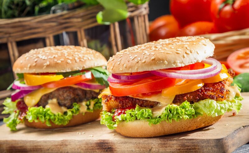 Two delicious burgers on a board