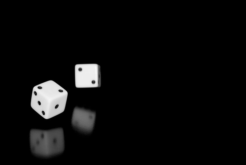 Two dice on black surface