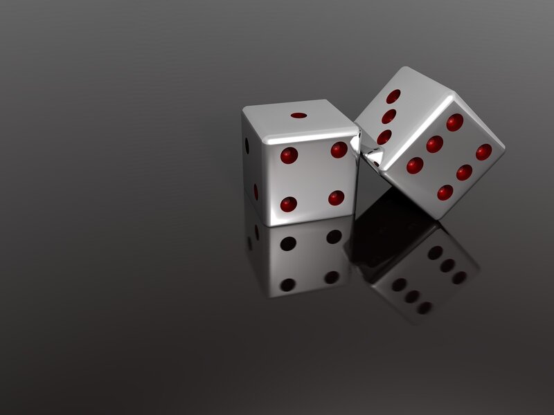 two dice on reflective surface