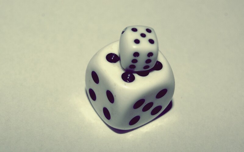 Two dice stacked on a surface