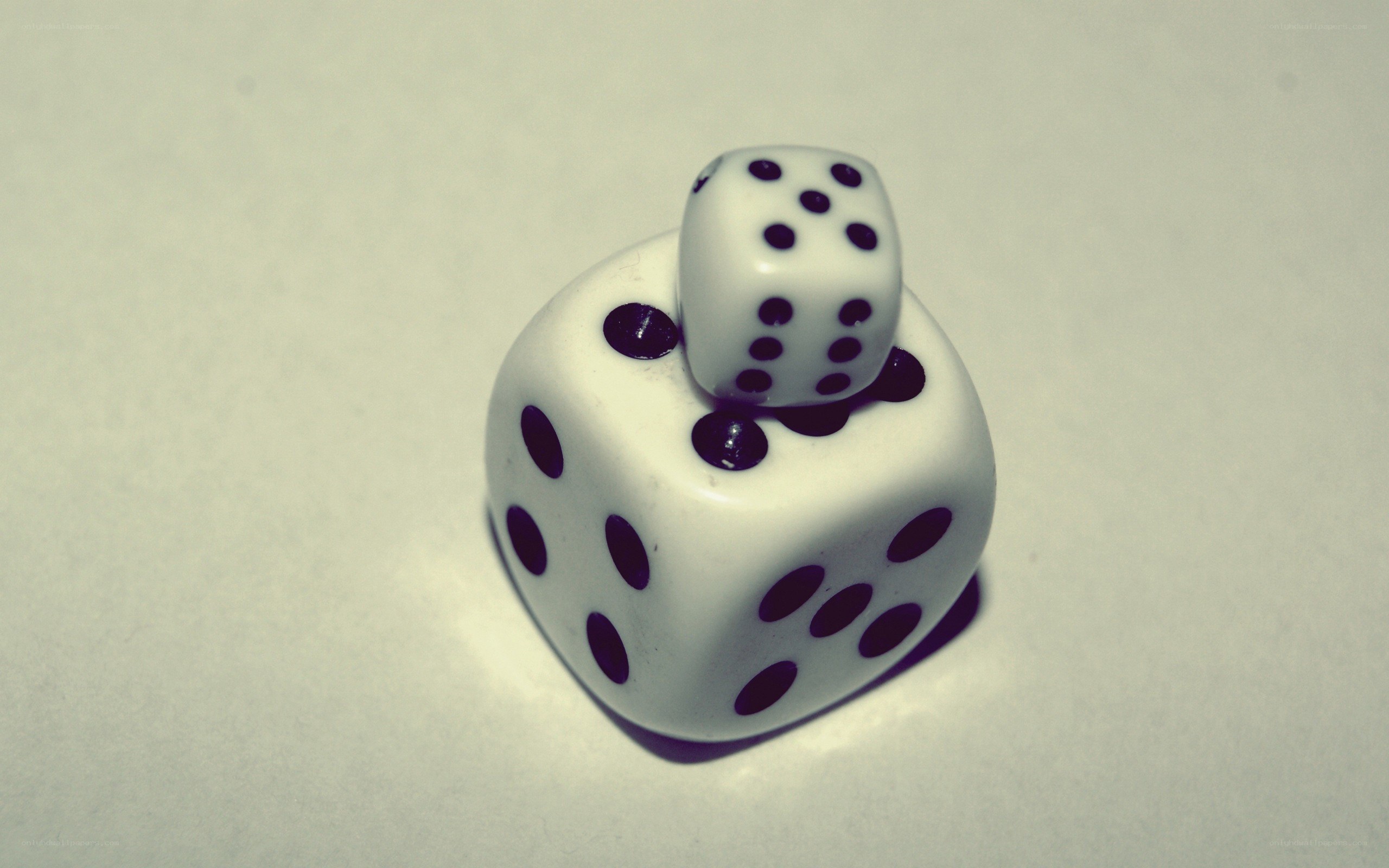 Two dice stacked on a surface