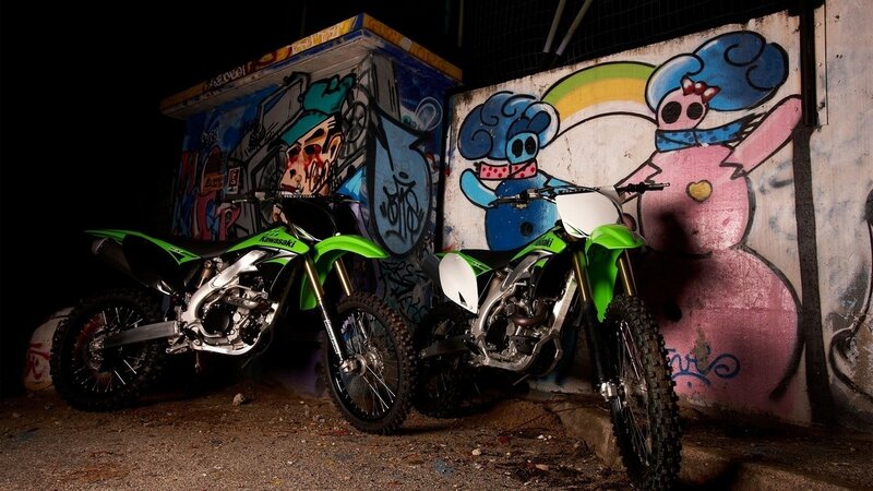 Two dirt bikes in graffiti alley
