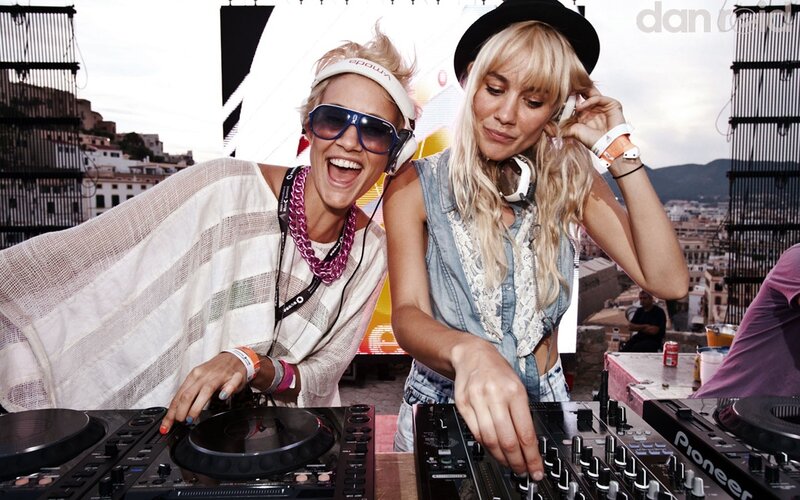 Two DJs performing at an outdoor event