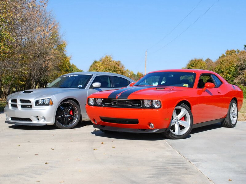 Two Dodge muscle cars parked