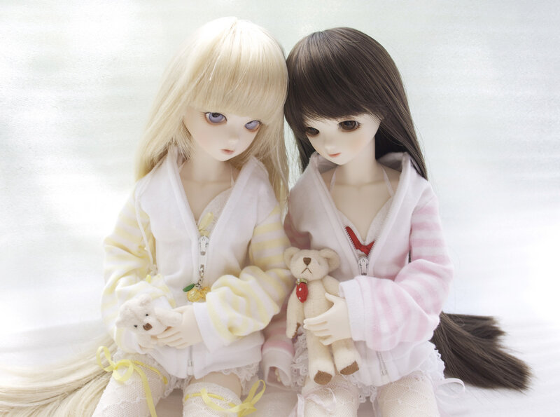 Two Dolls Holding Teddy Bears