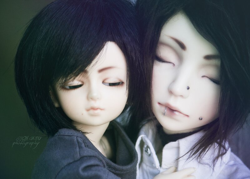 Two dolls in a close embrace