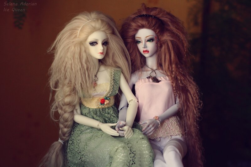 Two Dolls Sitting Together