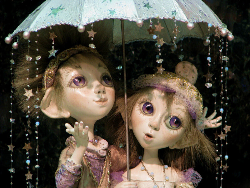 Two dolls under a starry umbrella