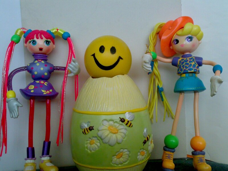 Two dolls with a smiley egg