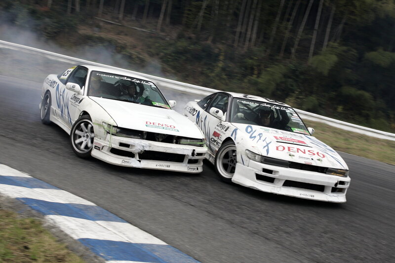 Two drift cars racing on track