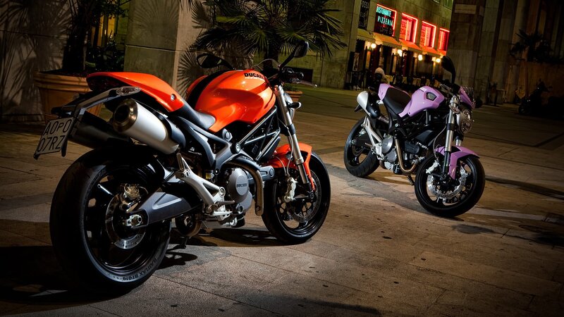 Two Ducati motorcycles at night