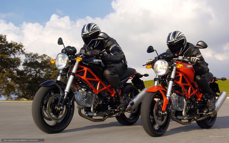 Two Ducati motorcycles on road