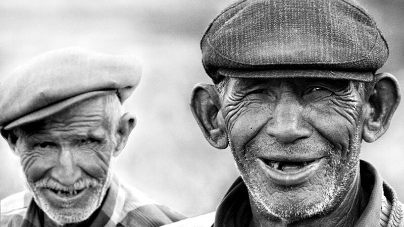 two elderly men smiling