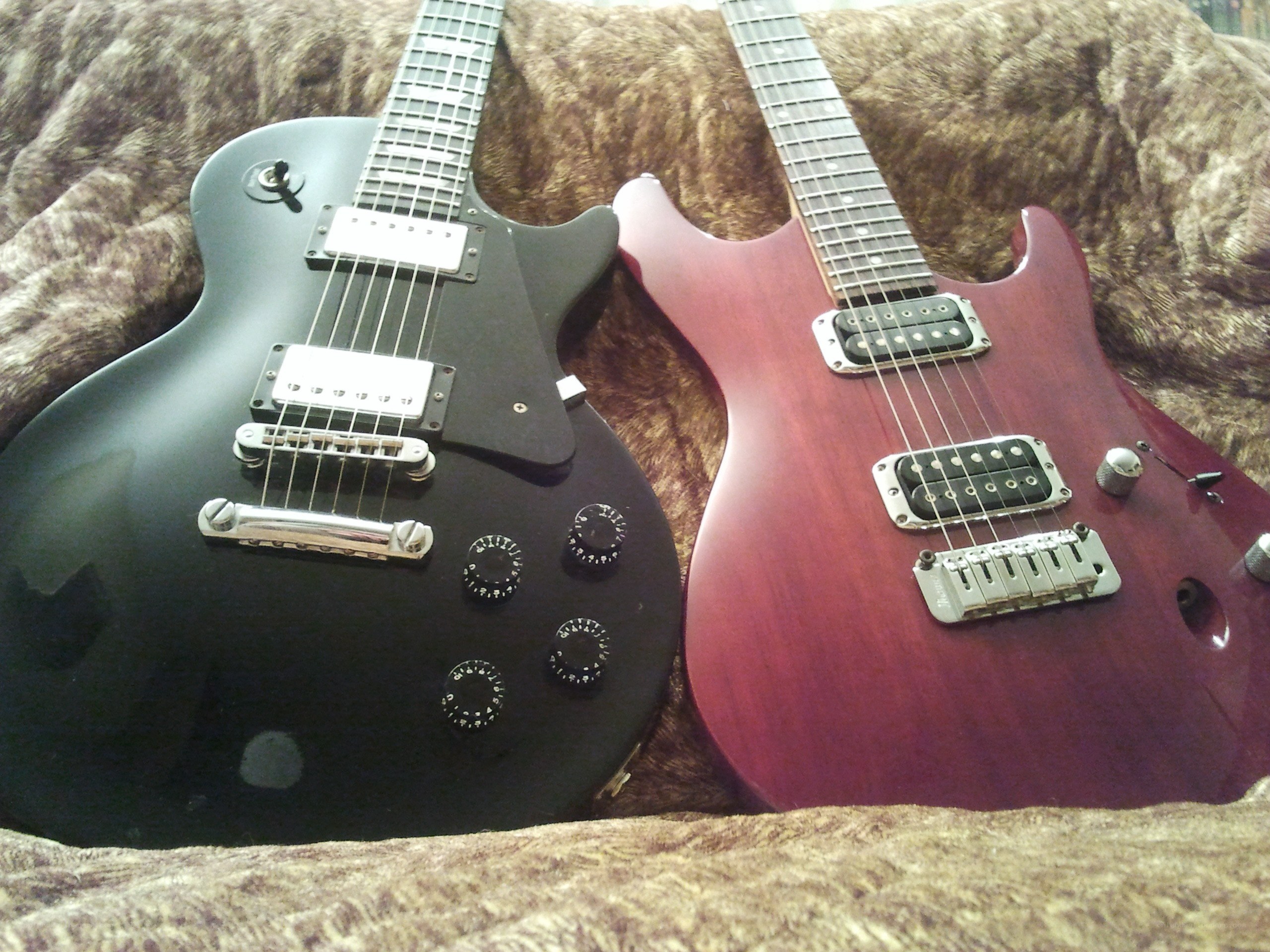 Two electric guitars on a blanket