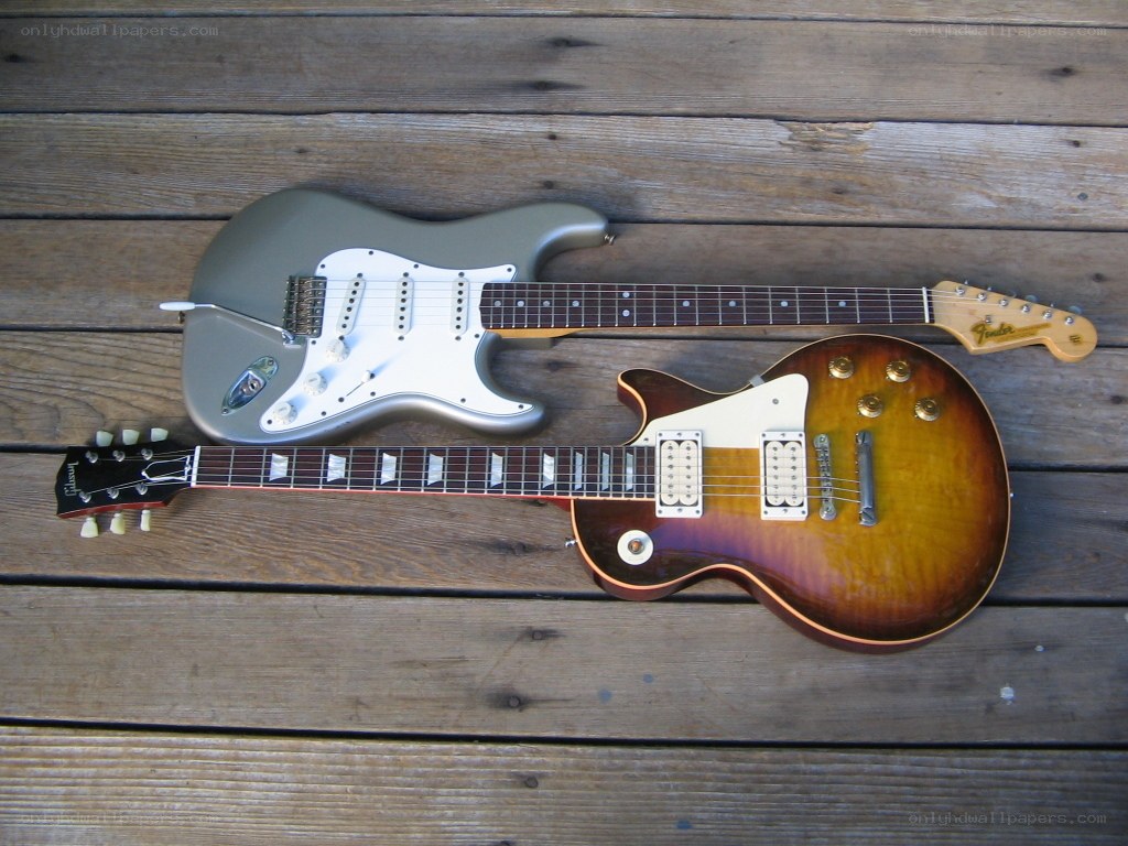 Two electric guitars on wood