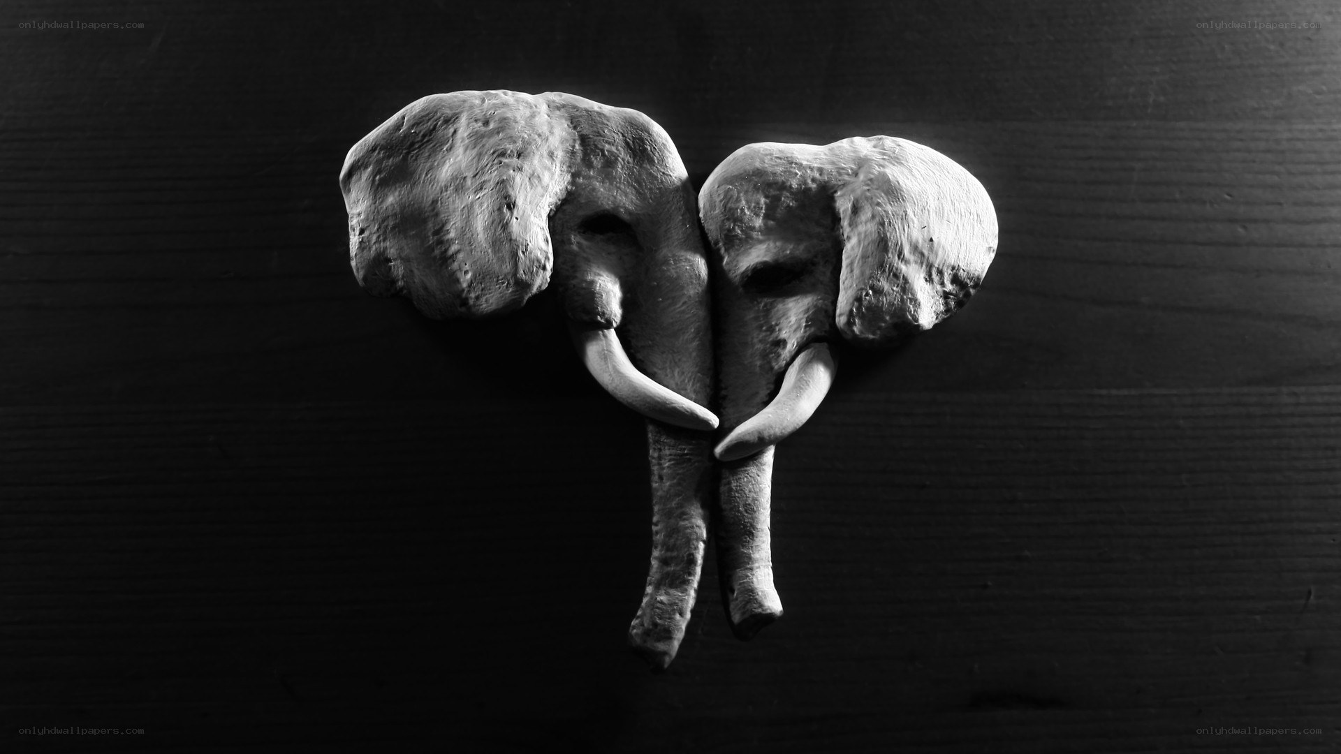 two elephant heads in clay