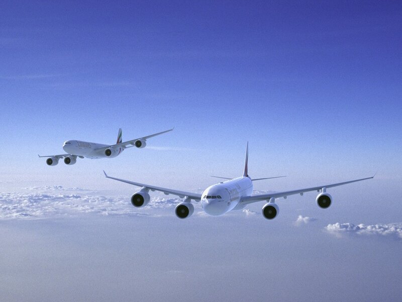 Two Emirates A380s in flight