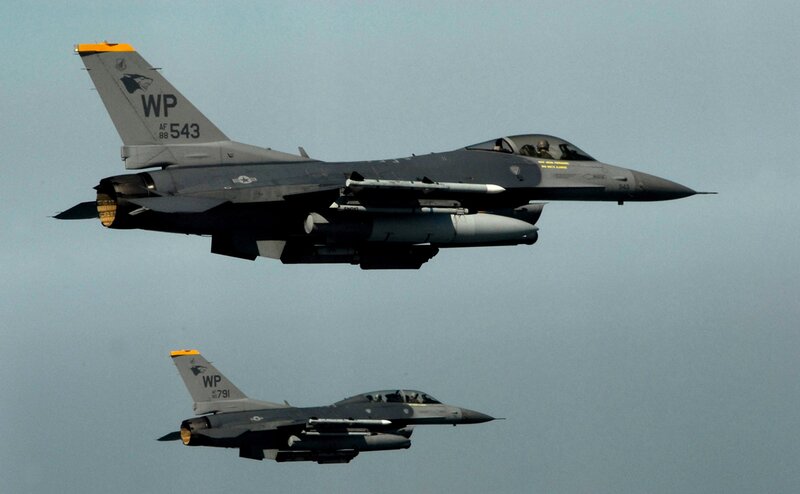 Two F-16 fighter jets in flight