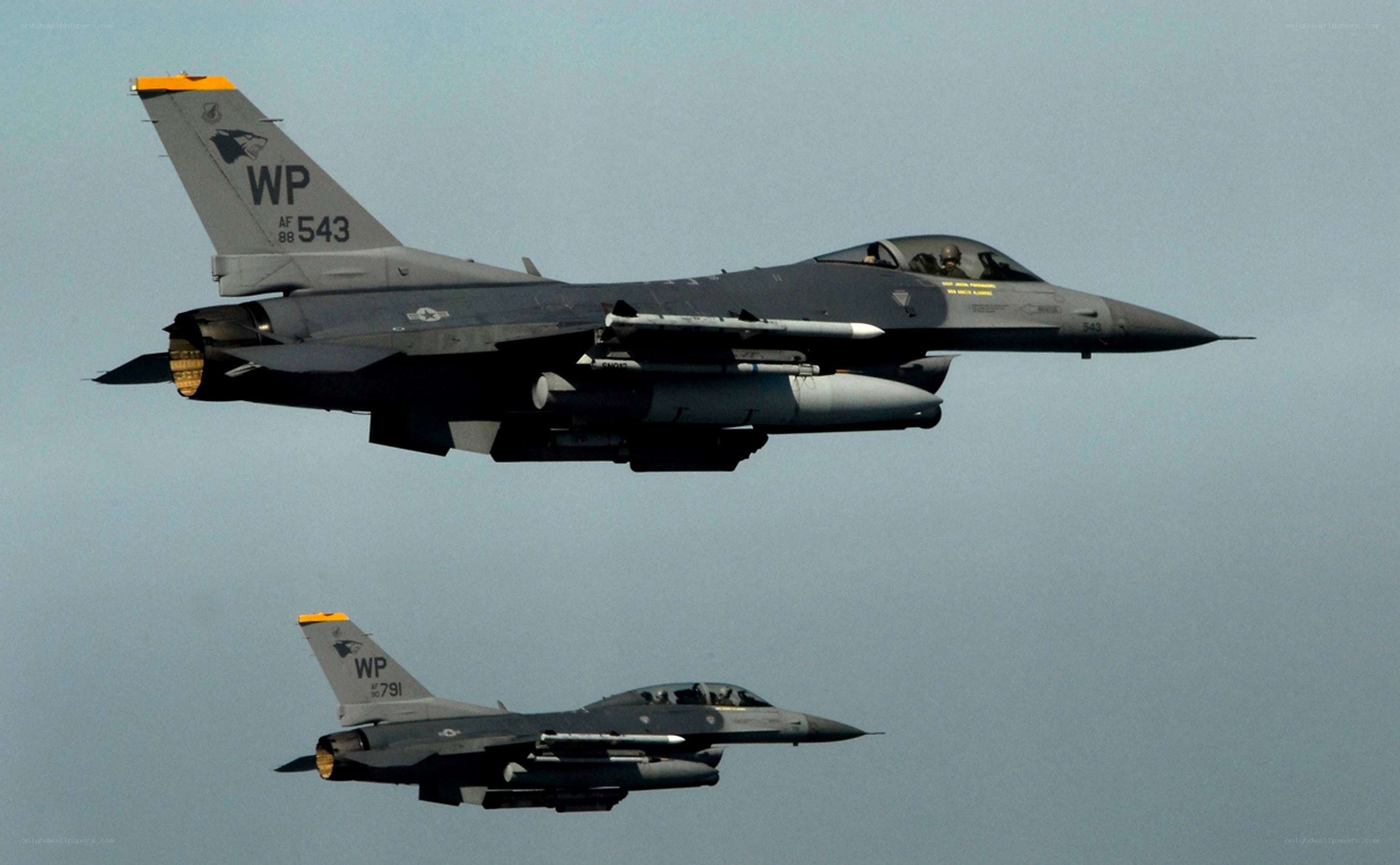 Two F-16 fighter jets in flight
