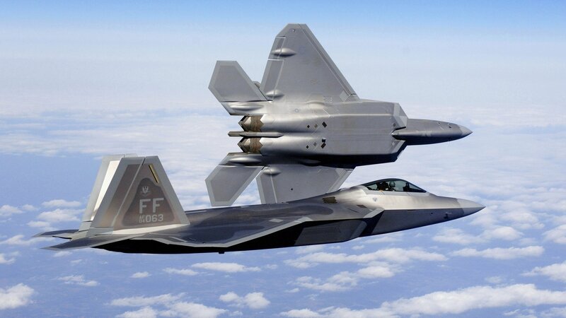 Two F-22 Raptors in flight