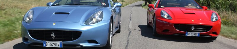Two Ferrari cars on a road