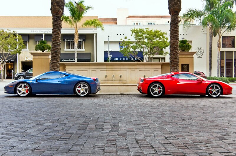 Two Ferraris on a cobblestone street