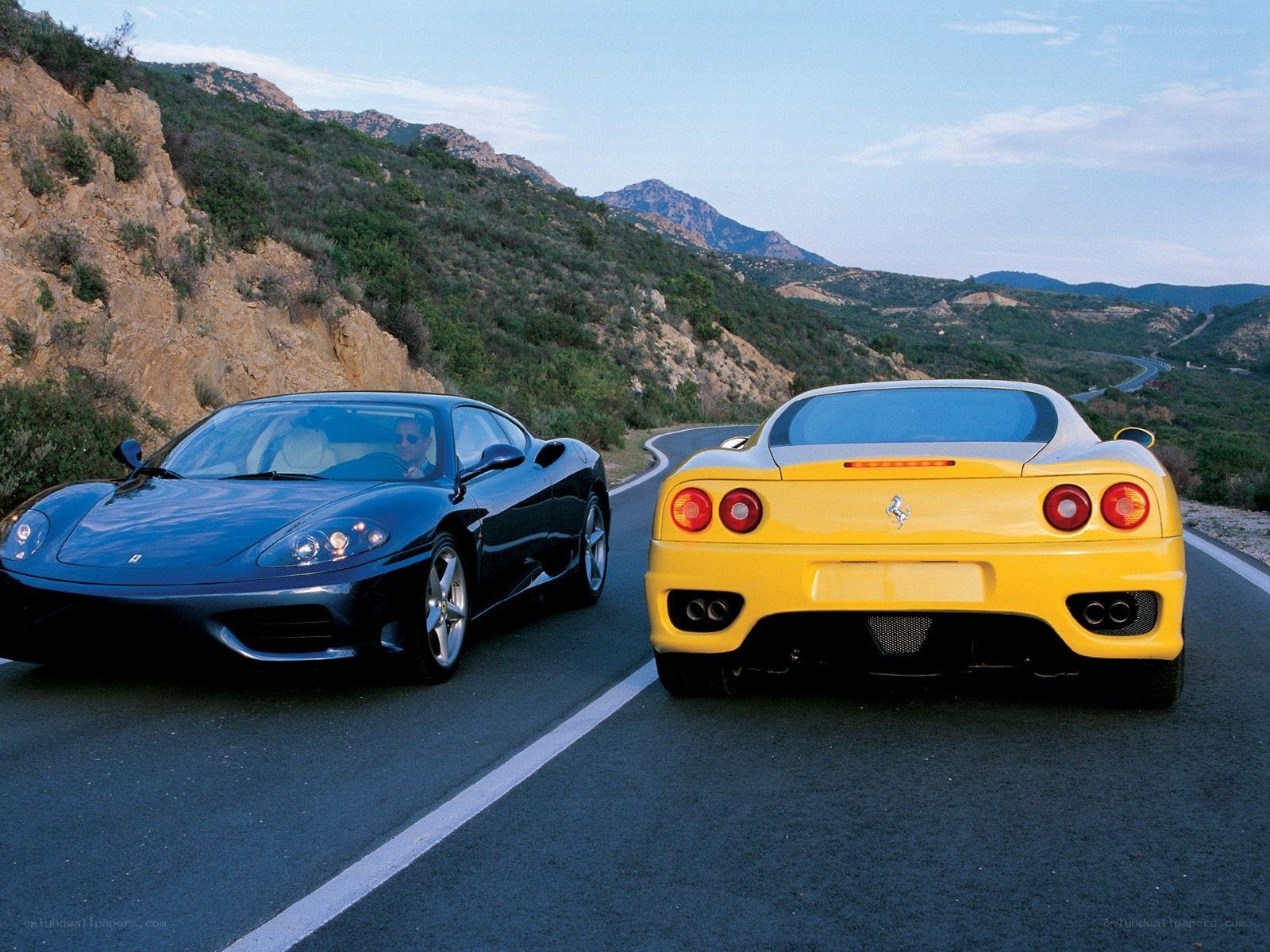 Two Ferraris on a mountain road