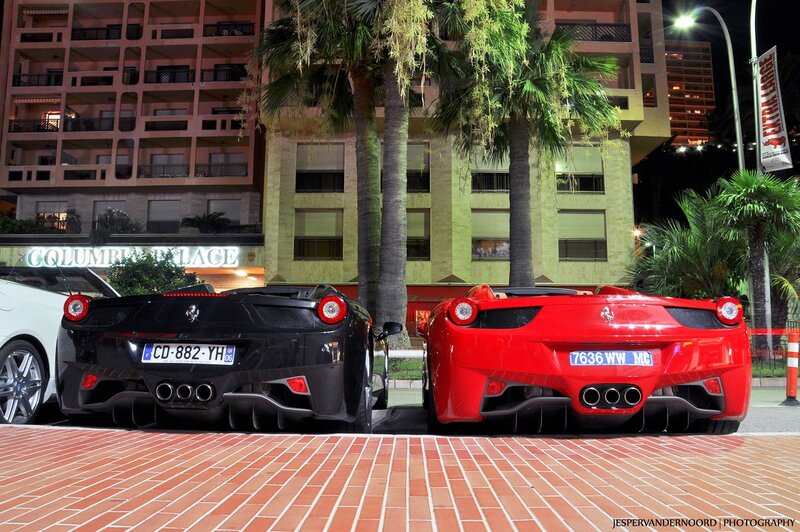 Two Ferraris parked at night