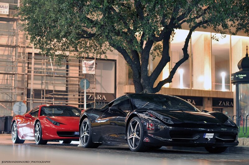 Two Ferraris parked on a city street