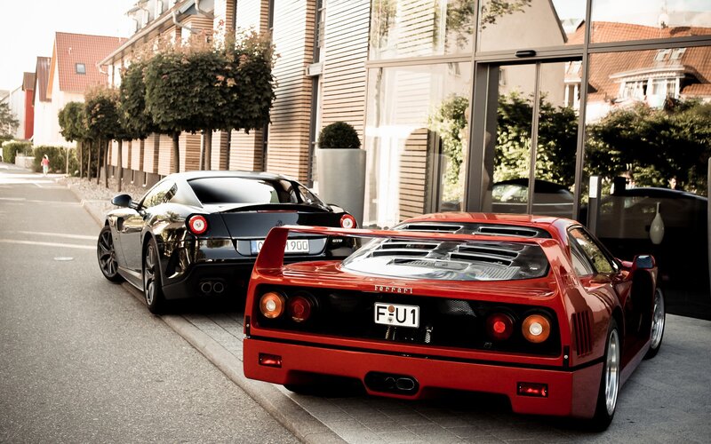 Two Ferraris parked on a street