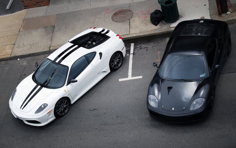 Two Ferraris parked on street