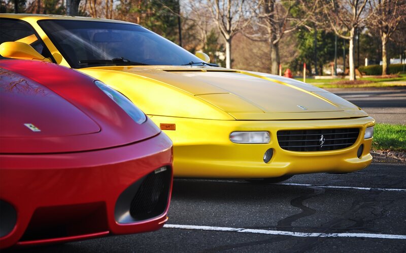 Two Ferraris parked side by side