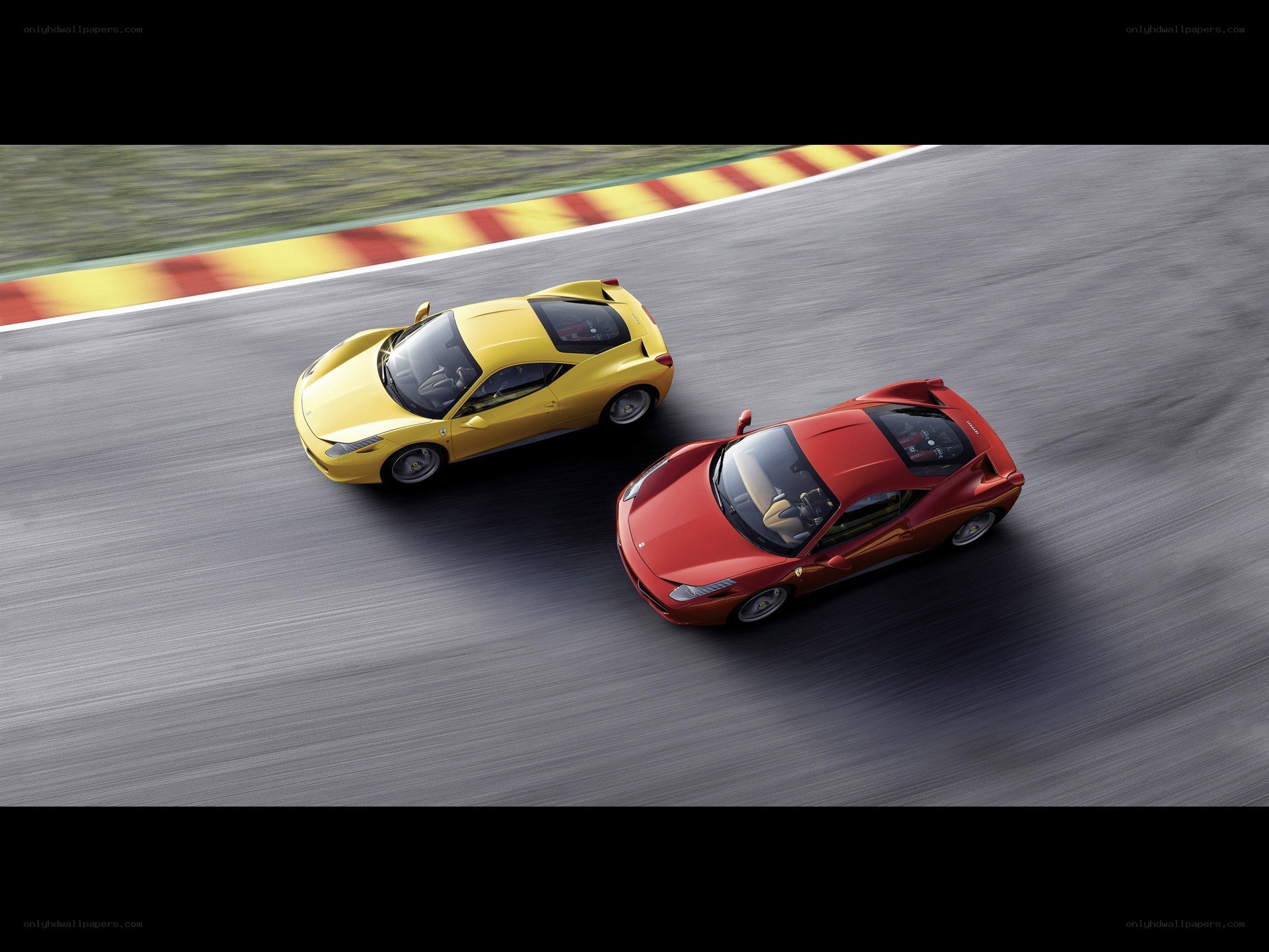 Two Ferraris racing on a track