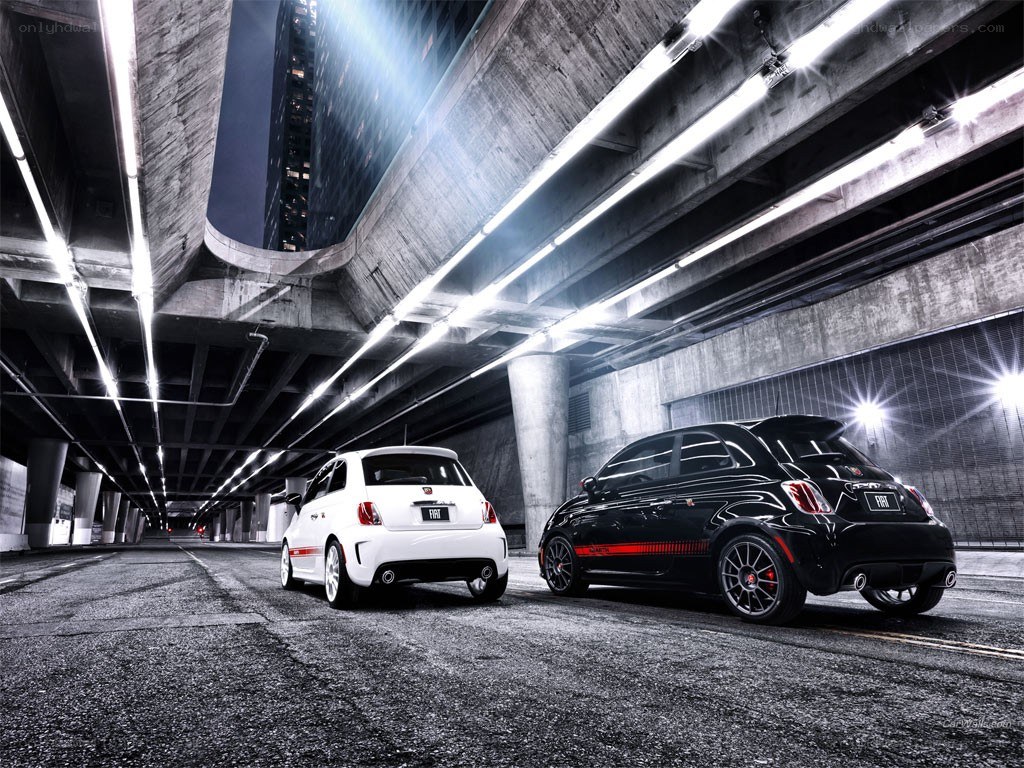Two Fiat 500s under a bridge
