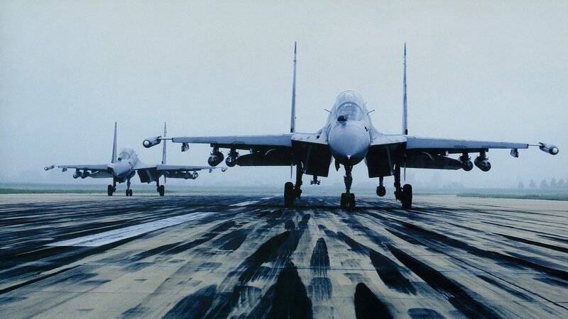 Two fighter jets on a runway