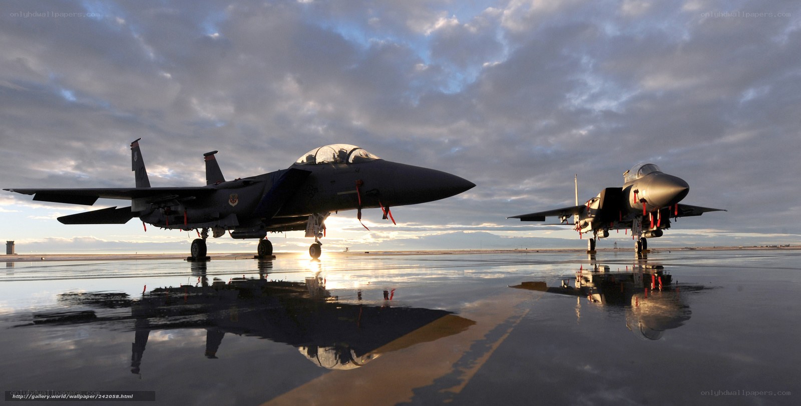 Two fighter jets on wet tarmac