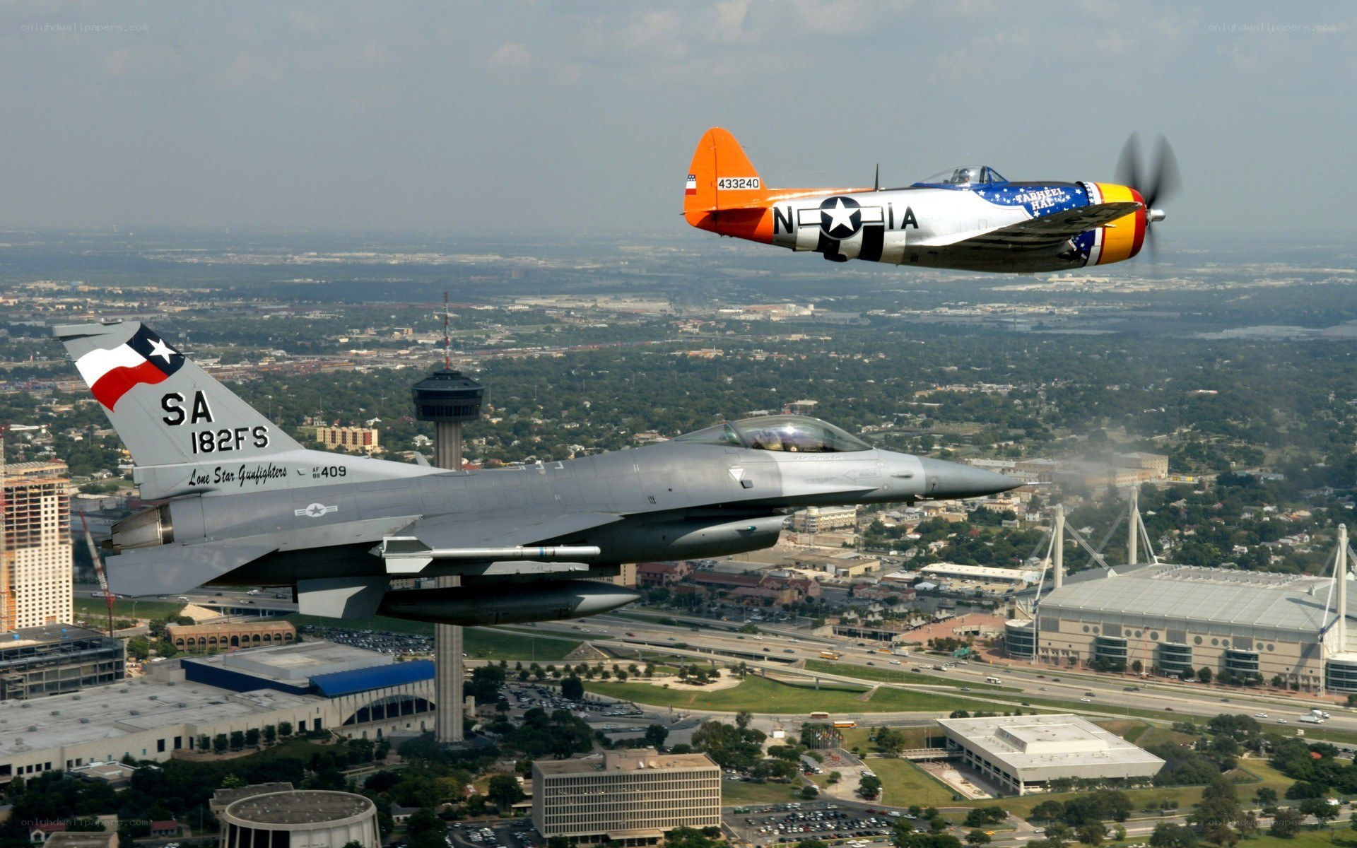 Two fighter jets over a city