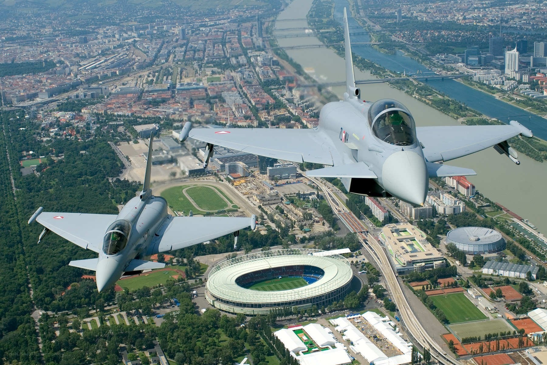 Two fighter jets over a city
